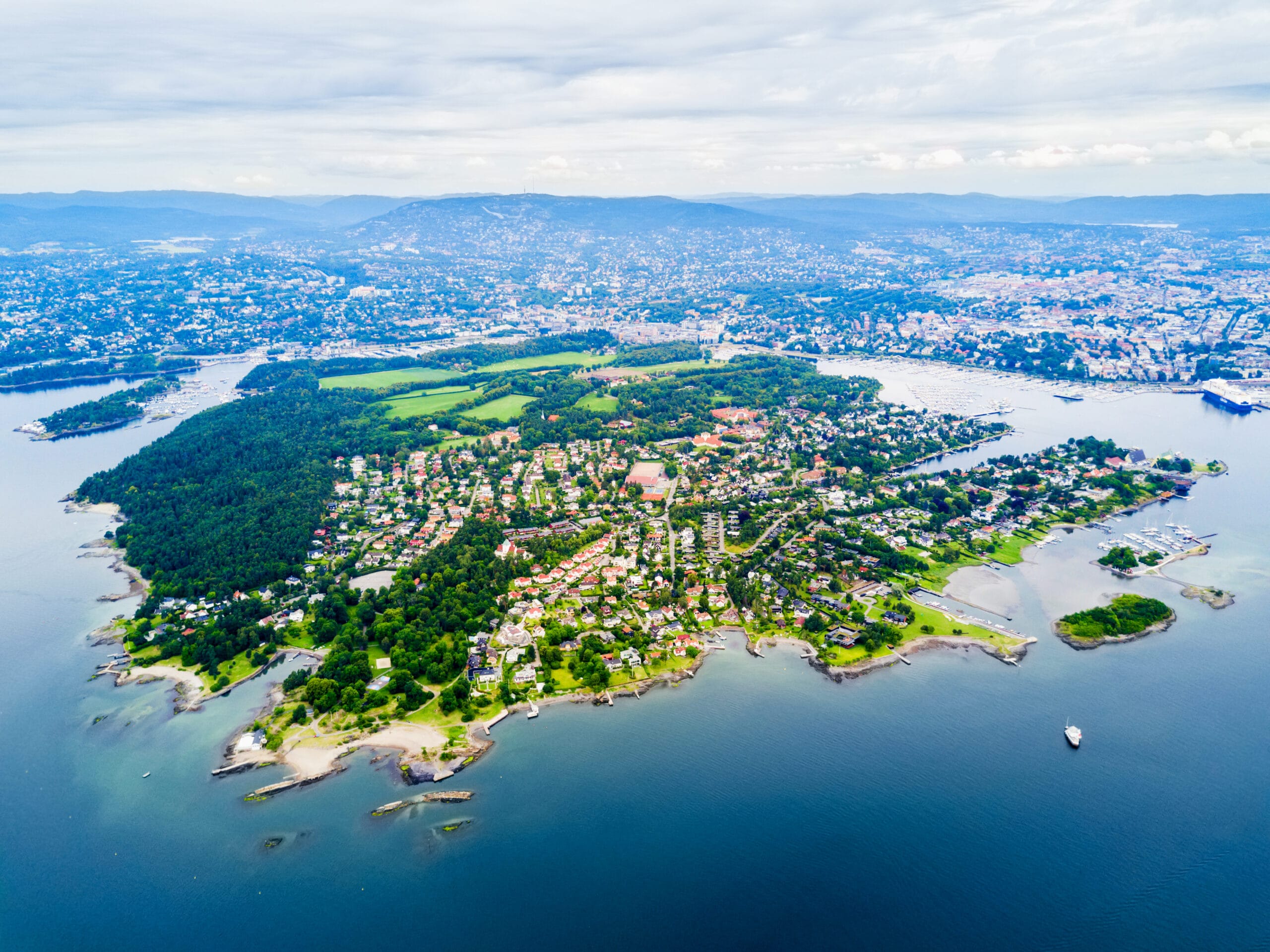Aerial view of green coastal peninsula and city