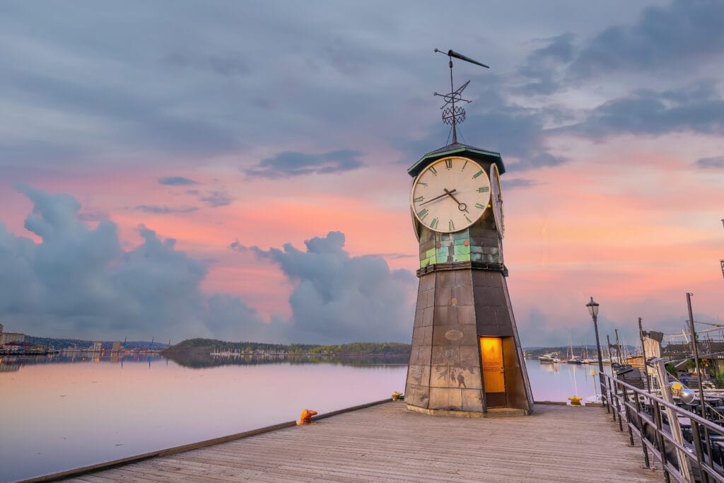 Clock tower on pier at sunset