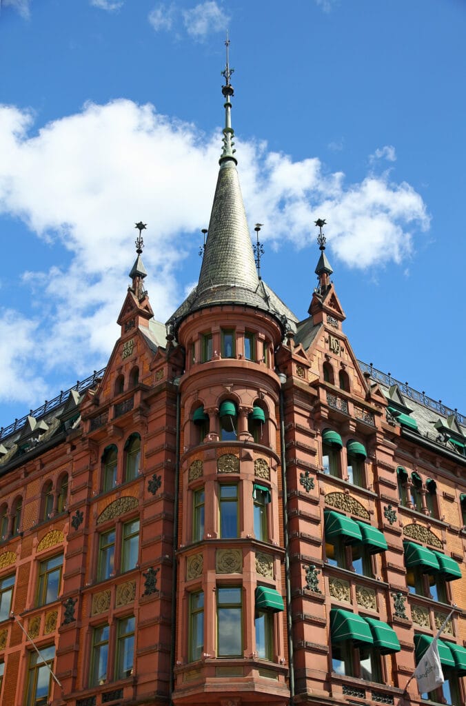 Ornate red-brick building with turret and spire