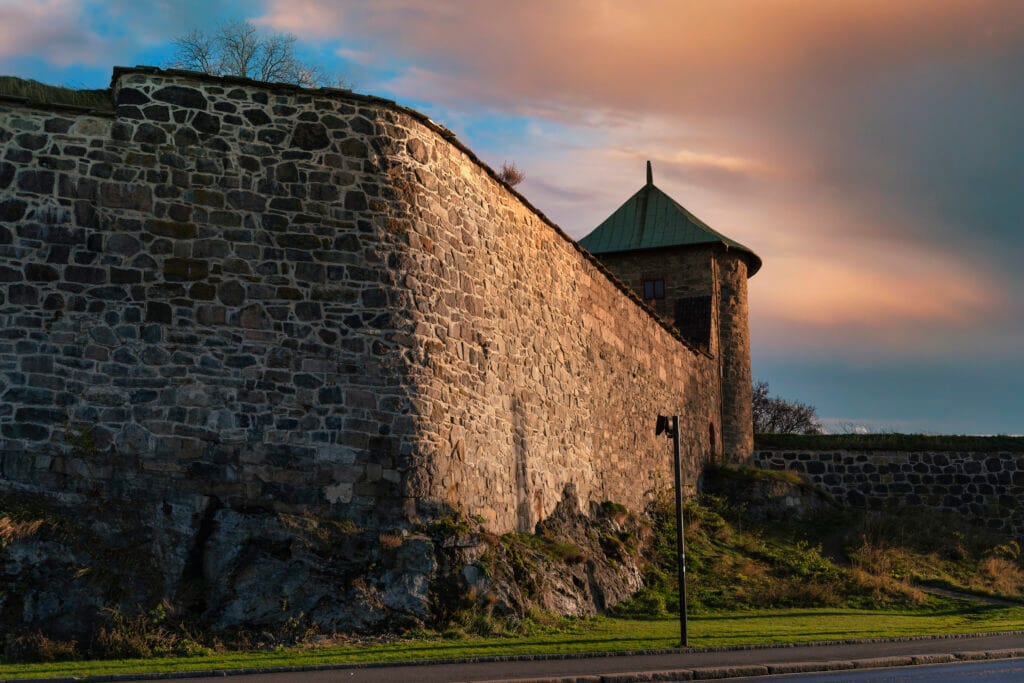 Stone fortress wall and tower at sunset