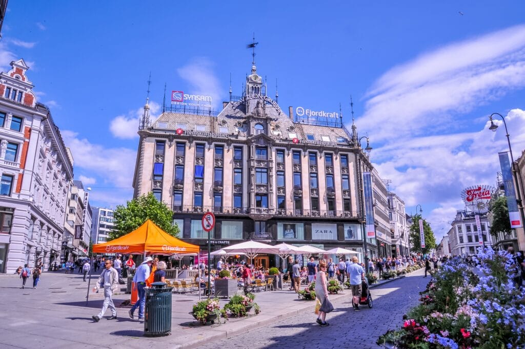 Busy city square with historic building and café