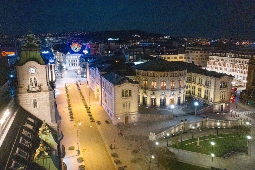 Illuminated historic theatre and cityscape at night