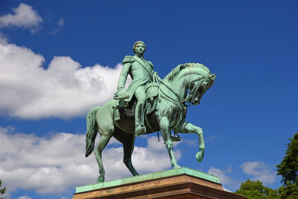 Equestrian statue of military figure against blue sky