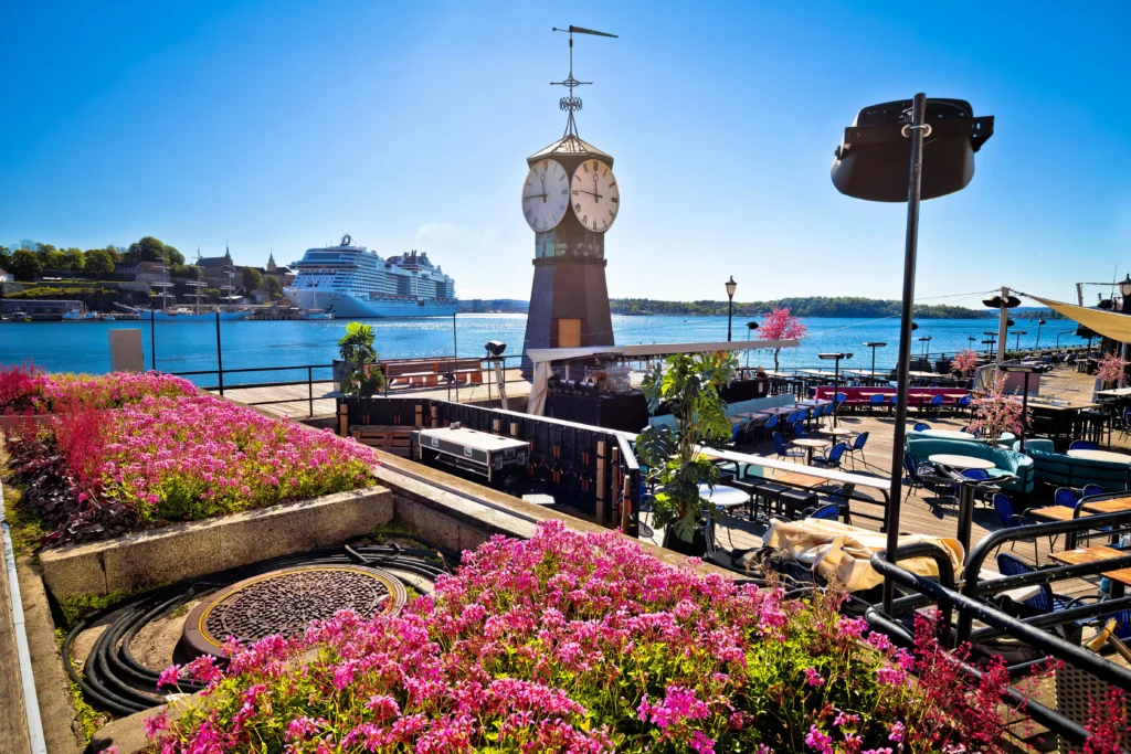 Harbour clock tower and cruise ship by waterfront